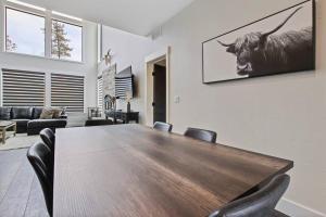 a dining room with a table and a cow on the wall at Modern Stunning 3 bedroom Cabin in Donnelly close in Donnelly