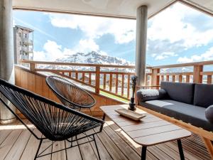 a balcony with a couch and chairs and a mountain at Superbe appartement 56m², accès pistes, terrasse sud, 1 suite parentale, proche centre et ESF - FR-1-634-5 in Avoriaz