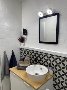 łazienka z białą umywalką i lustrem w obiekcie CÉNTRICO APARTAMENTO REFORMADO EN ARANJUEZ w mieście Aranjuez +8 zdjęć