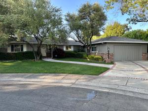 a house with a garage and a driveway at Secluded Home w/pool 5 minutes from American River in Carmichael