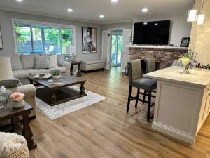 a living room with a couch and a table at Secluded Home w/pool 5 minutes from American River in Carmichael