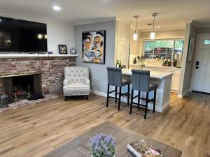 a living room with a fireplace and a table and chairs at Secluded Home w/pool 5 minutes from American River in Carmichael