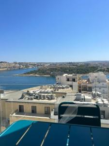 a view of a city with a river and buildings at Eleven by Warren Collection in Sliema