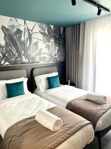 a hotel room with two beds and a mural at Eleven by Warren Collection in Sliema