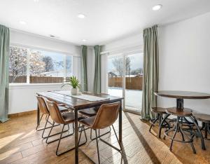 a dining room with a table and chairs at Modern home near UVU and BYU with hot tub and mountain views in Orem