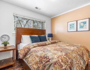 a bedroom with a large bed and a window at Modern home near UVU and BYU with hot tub and mountain views in Orem