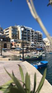 two boats in a body of water with buildings at Eleven by Warren Collection in Sliema