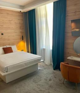 a bedroom with a bed and a large window at A8 b&b in Zagreb
