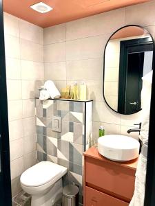 a bathroom with a toilet and a mirror at Eleven by Warren Collection in Sliema