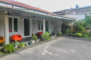 a house with plants sitting outside of it at Hotel Cemerlang in Baturaden