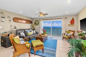 a living room with a leather couch and chairs at Breathtaking Ocean View of Royal Waters! AK5202 in Princeville