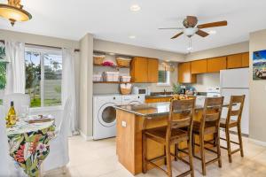 a kitchen with a kitchen island with a dishwasher at Breathtaking Ocean View of Royal Waters! AK5202 in Princeville