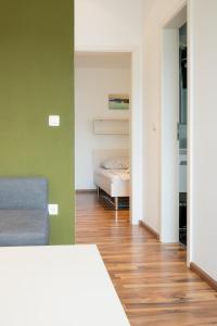 a living room with a couch and a bedroom at VDL Apartments in Trogir