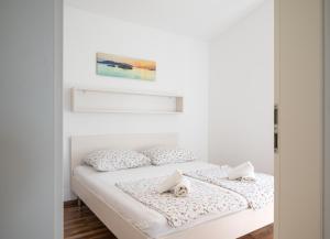 a bedroom with a bed with two pillows at VDL Apartments in Trogir