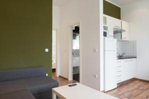 a living room with a couch and a kitchen at VDL Apartments in Trogir