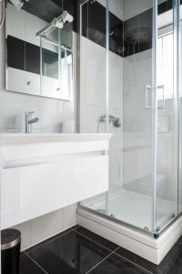 a bathroom with a glass shower and a sink at VDL Apartments in Trogir