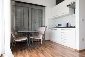 a kitchen and dining room with a table and chairs at VDL Apartments in Trogir