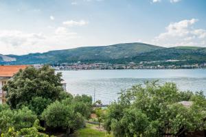 a view of a large body of water with trees at VDL Apartments in Trogir