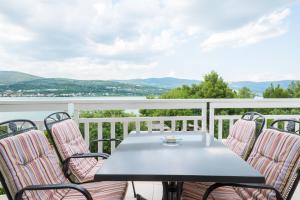 a table and chairs on a balcony with a view at VDL Apartments in Trogir