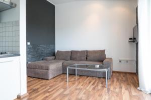 a living room with a couch and a glass table at VDL Apartments in Trogir