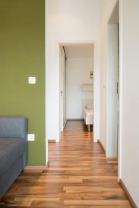 a hallway with green and white walls and wooden floors at VDL Apartments in Trogir +37 photos