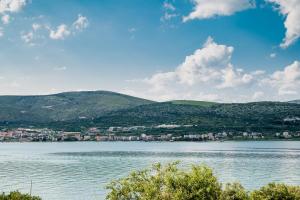 a view of a large body of water with mountains at VDL Apartments in Trogir