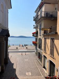 a view of the ocean from between two buildings at La Motta in Belgirate
