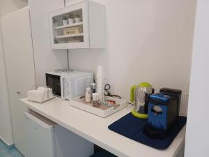 a kitchen with a counter with a microwave on it at due stanzulelle sul mare B&B in Salerno