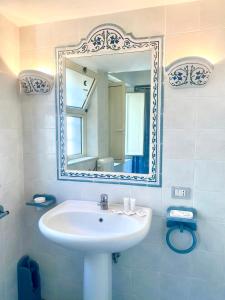 a bathroom with a sink and a mirror at Casa Ignazia in Taormina