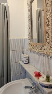 a bathroom with a sink and a mirror at Sanacore - Maratea - Cersuta in Maratea