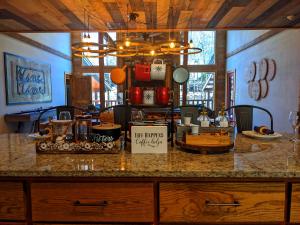 a kitchen with a counter with a table with food on it at Wine Time 5 Bedroom Shuffleboard Hot Tub Fire Pit Play Set in Broken Bow