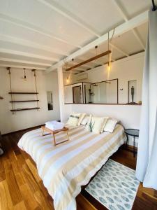 a bedroom with a large bed with a table on it at ZANNANNA LODGE in Le Diamant