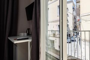 a room with a balcony with a view of a city at Elite del Centro Storico in Naples