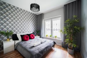 a bedroom with a large bed with red pillows at New Apartment OLD TOWN - 3 Rooms - 7 People - Parking Place - Kościuszki Street in Wrocław
