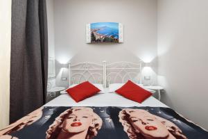 a bedroom with a bed with two faces on it at Elite del Centro Storico in Naples