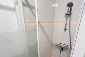 a shower with a glass door next to a toilet at Bord de mer proche du port 500m de La Baule in Le Pouliguen +16 photos