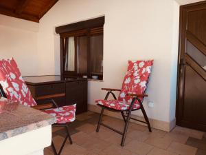 a living room with two chairs and a table at Apartments Classic#BnM in Biograd na Moru