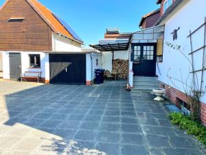a patio outside of a house with a building at RobinsHomes-Weddel in Cremlingen