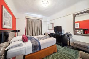 a hotel room with a bed and a television at Union Square Plaza Hotel in San Francisco