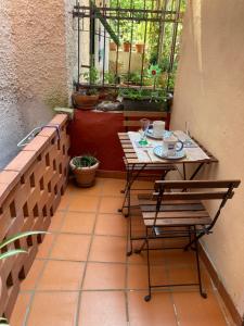 a table and chairs on a patio with a window at La Caponera in Riccò del Golfo di Spezia