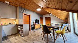a kitchen and dining room with a table and chairs at SnežienkaD in Starý Smokovec