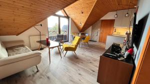 a living room with a couch and a table at SnežienkaD in Vysoké Tatry