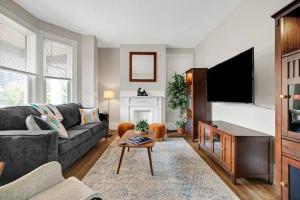 sala de estar con sofá y TV de pantalla plana en Victorian Home in Mt. Washington en Pittsburgh