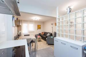 uma cozinha e sala de estar com um sofá e uma mesa em Apartamento en Santoña em Santoña