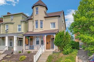 a large yellow house with a clock tower at Victorian Home in Mt. Washington in Pittsburgh