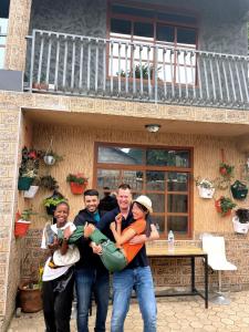 a group of people standing in front of a house at we are one apartment in Arusha