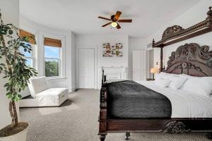 a bedroom with a large bed and a ceiling fan at Victorian Home in Mt. Washington in Pittsburgh