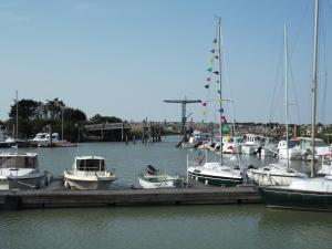 a group of boats docked at a dock in the water at Camping Paradis 4 étoiles Au Port de L'Houmeau - La Rochelle in LʼHoumeau
