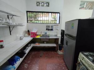 a small kitchen with a sink and a refrigerator at VILLA ELSA in El Colegio