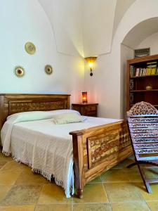 een slaapkamer met een bed en een boekenplank bij Resort La Casa Dei Fiori in Pantelleria